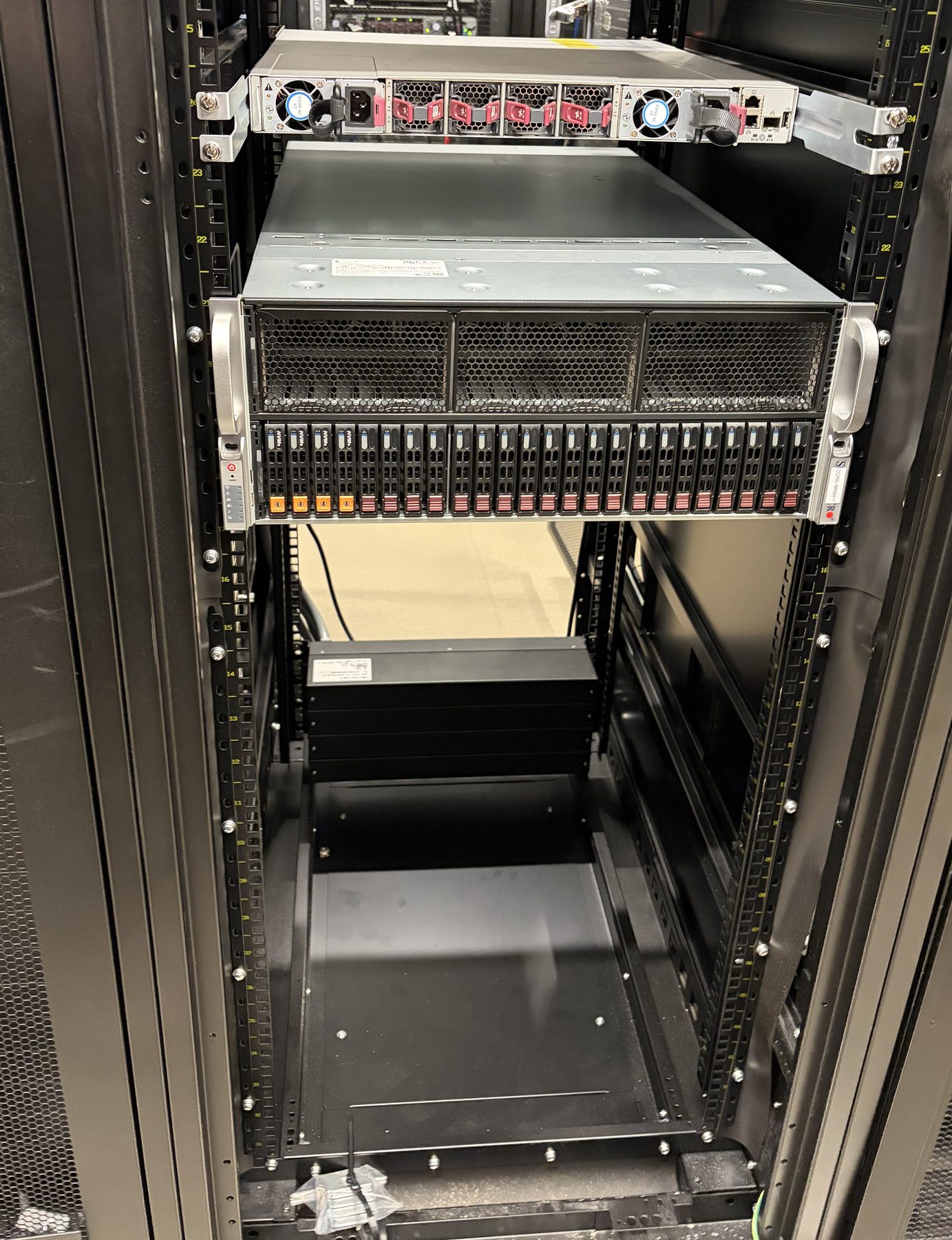 A Cornami MX64 compute chassis mounted in the cabinet, twenty-four front drive bays.